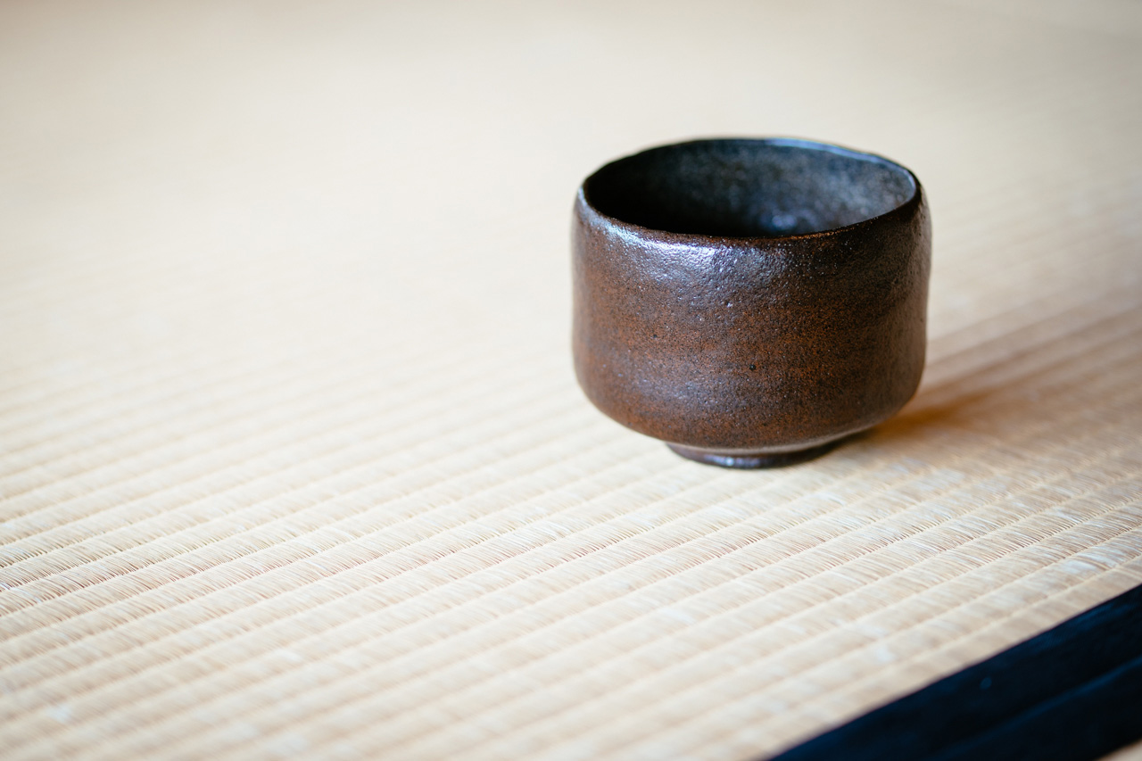 A traditional Japanese teacup placed on a tatami mat