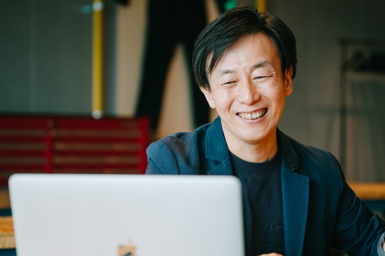 Yoshihisa Aono smiling as he talks about the wrestling club